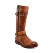 The Bed Stu Gogo Lug is a brown mid-calf leather boot featuring a side zipper, buckle straps, a red sole, and a durable lug outsole.