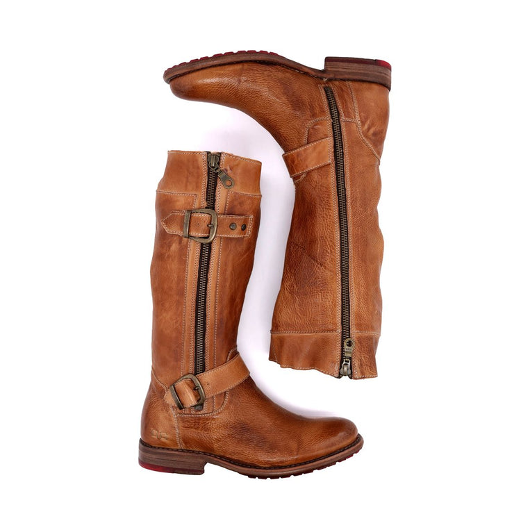 A pair of Bed Stu's Gogo Lug brown leather knee-high boots with side zippers and buckle details, featuring a durable lug outsole, laid flat against a white background.