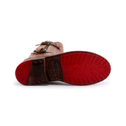 A single brown Gogo Lug mid-calf leather boot from Bed Stu is laying on its side, showcasing a red rubber sole and metal studs near the heel. The brand "Bed Stu" is visible on the arch, and its durable lug outsole promises long-lasting wear.