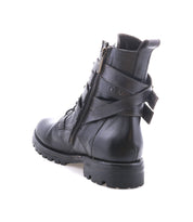 The Bed Stu Grab is a black leather combat-inspired lace-up boot with a side zipper, Vibram rubber lug sole, and back buckle detail, shown against a white background.