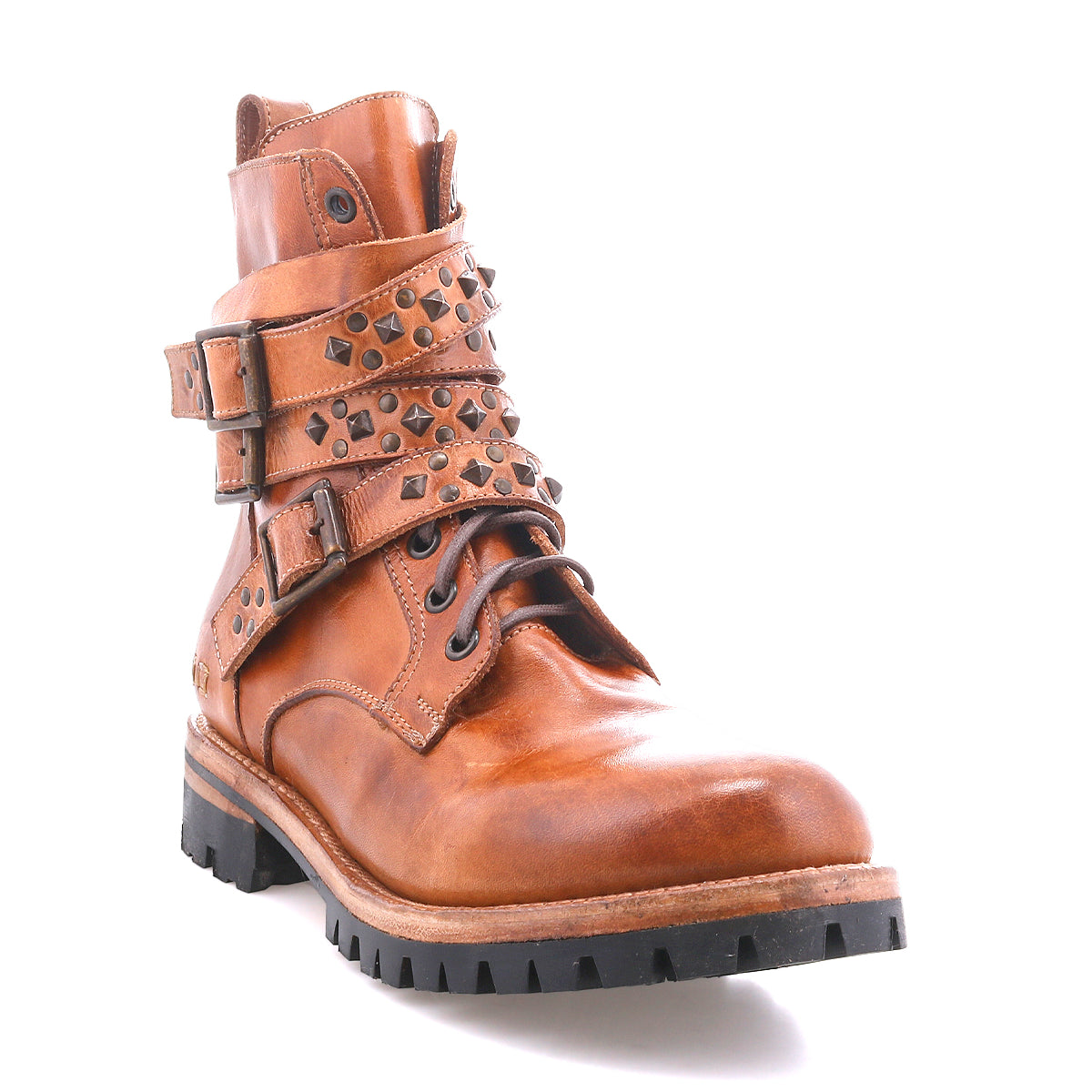 The Bed Stu Grab is a brown leather combat-inspired boot with studded buckle straps, metal studs, and a durable black Vibram lug sole, shown against a white background.