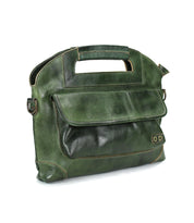 The Bed Stu Greenway is a green leather crossbody bag featuring a built-in handle, front flap pocket, secure zipper, and visible stitching.
