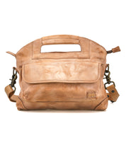 The Bed Stu Greenway is a stylish light brown leather handbag with a built-in handle, front flap pocket, secure zipper, and detachable shoulder strap—perfect as a chic crossbody, shown against a white background.