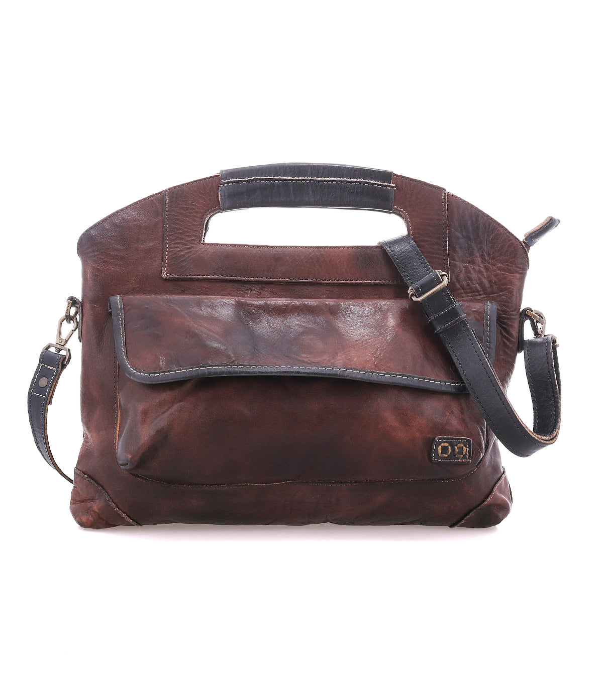 The Bed|Stü Greenway is a brown leather shoulder bag crafted from full-grain leather with black accents, featuring a spacious front pocket, adjustable crossbody strap, integrated top handle, and a secure zip-top closure to keep your essentials safe.