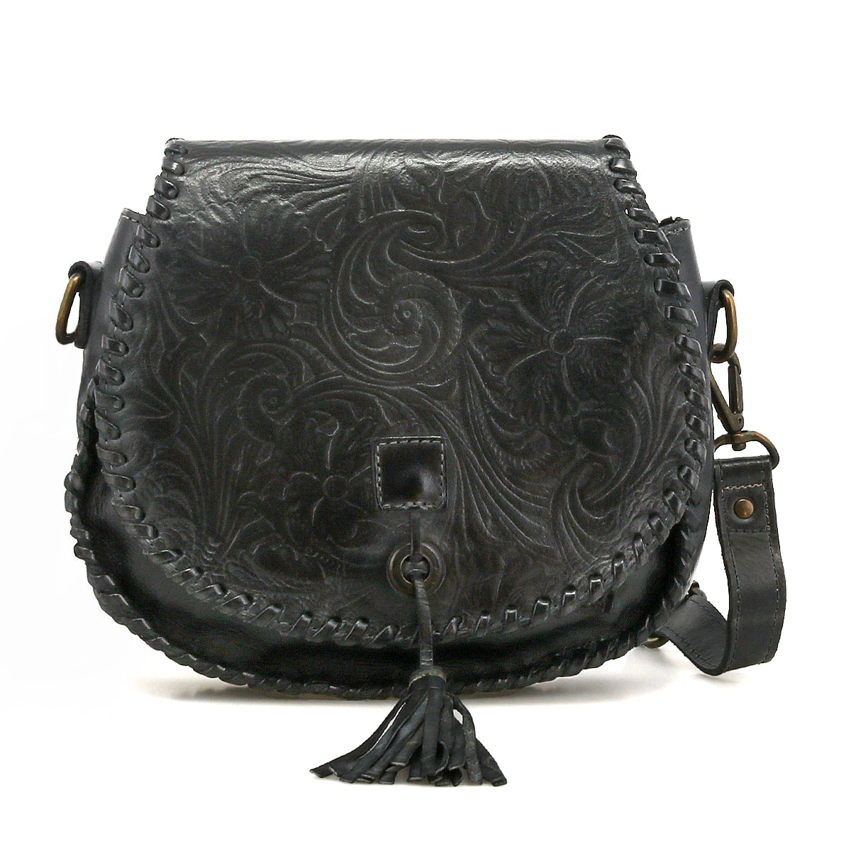 The Bed Stu Half Moon EM is a black leather saddlebag crossbody with an embossed foliage pattern, front flap, braided edges, leather tassel, and adjustable strap.