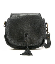 The Bed Stu Half Moon EM is a black leather saddlebag crossbody with an embossed foliage pattern, front flap, braided edges, leather tassel, and adjustable strap.