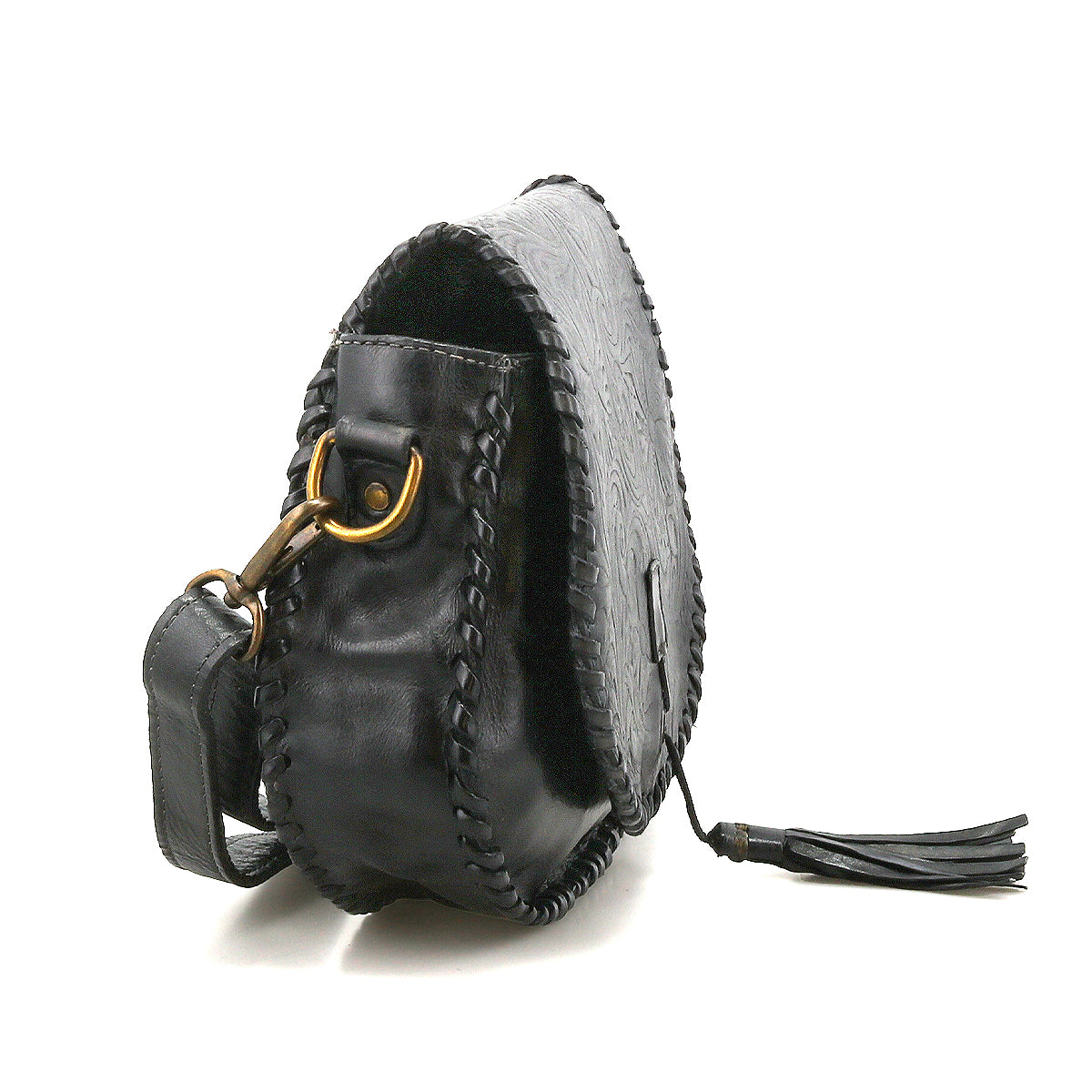 Bed Stu’s Half Moon EM is a black leather saddlebag crossbody purse featuring stitched edges, brass hardware, and a leather tassel zipper pull, shown at an angle to highlight its side and strap.