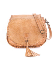 The Bed Stu Half Moon EM is a light brown leather crossbody purse featuring an embossed foliage pattern, whipstitch edges, adjustable strap, and a front tassel detail.