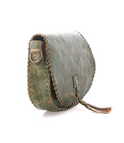 The Half Moon by Bed Stu is a small green leather crossbody purse with visible edge stitching, a front flap closure, and a leather tassel accent.