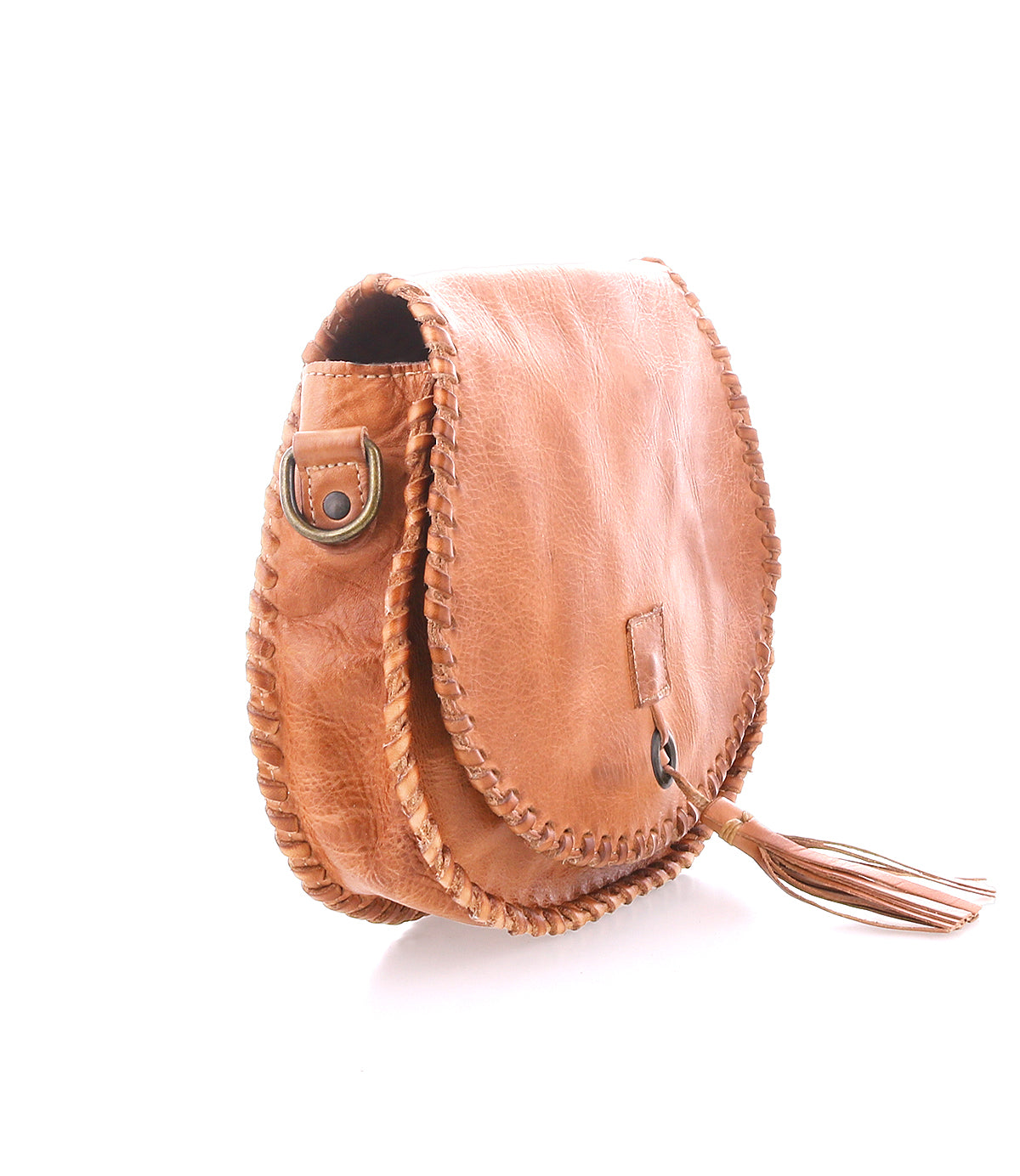 The Bed Stu Half Moon is a tan leather crossbody purse with whipstitch details, metal ring accent, adjustable strap, and a chic leather tassel on the front flap, shown against a white background.