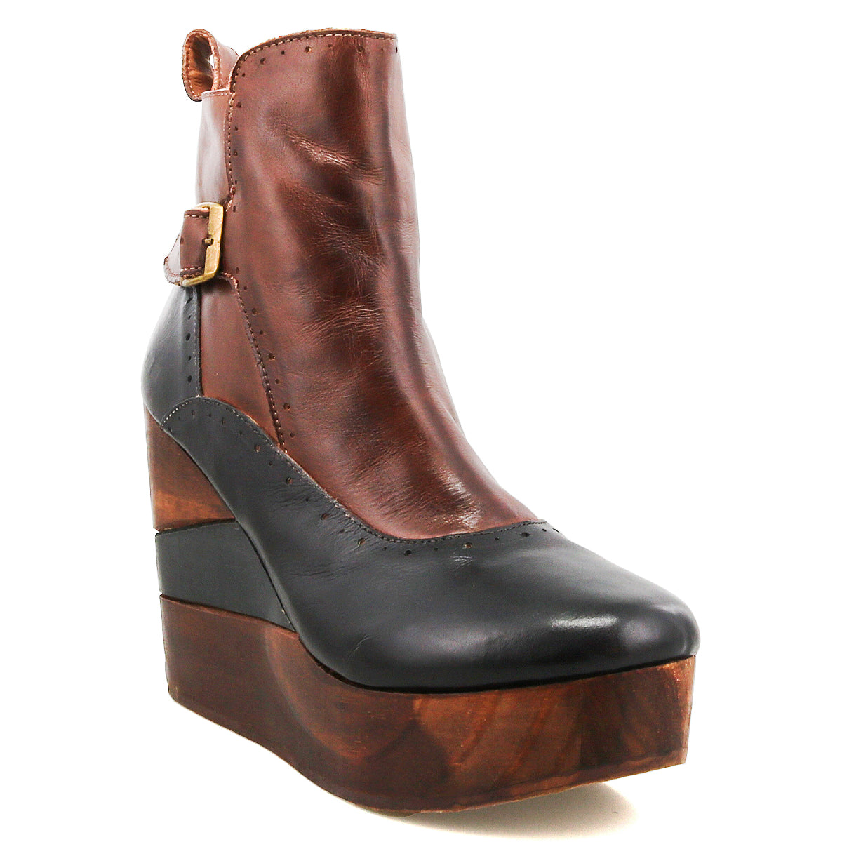 The Bed Stu Harmonious is a brown and black leather Platform Wedge Ankle Boot with a sculptural wood wedge sole, brogue-style perforations, and a decorative side buckle.
