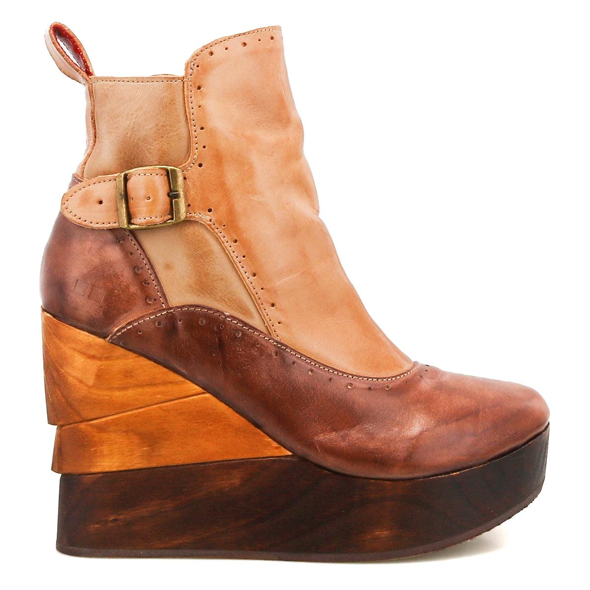 The Bed Stu Harmonious is a brown and tan platform wedge ankle boot with a leather upper, brogue perforations, buckle detail, and a layered sculptural wood wedge sole.