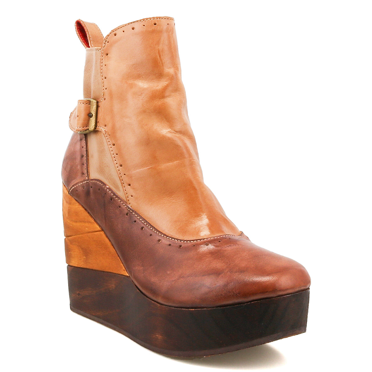 The Bed Stu Harmonious is a brown and tan leather platform wedge ankle boot featuring brogue perforations, a buckle accent, and a sculptural wooden wedge sole.