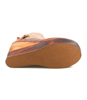 A close-up view of the bottom sole of the Bed Stu Harmonious, a tan leather Platform Wedge Ankle Boot featuring a flat, textured rubber outsole.