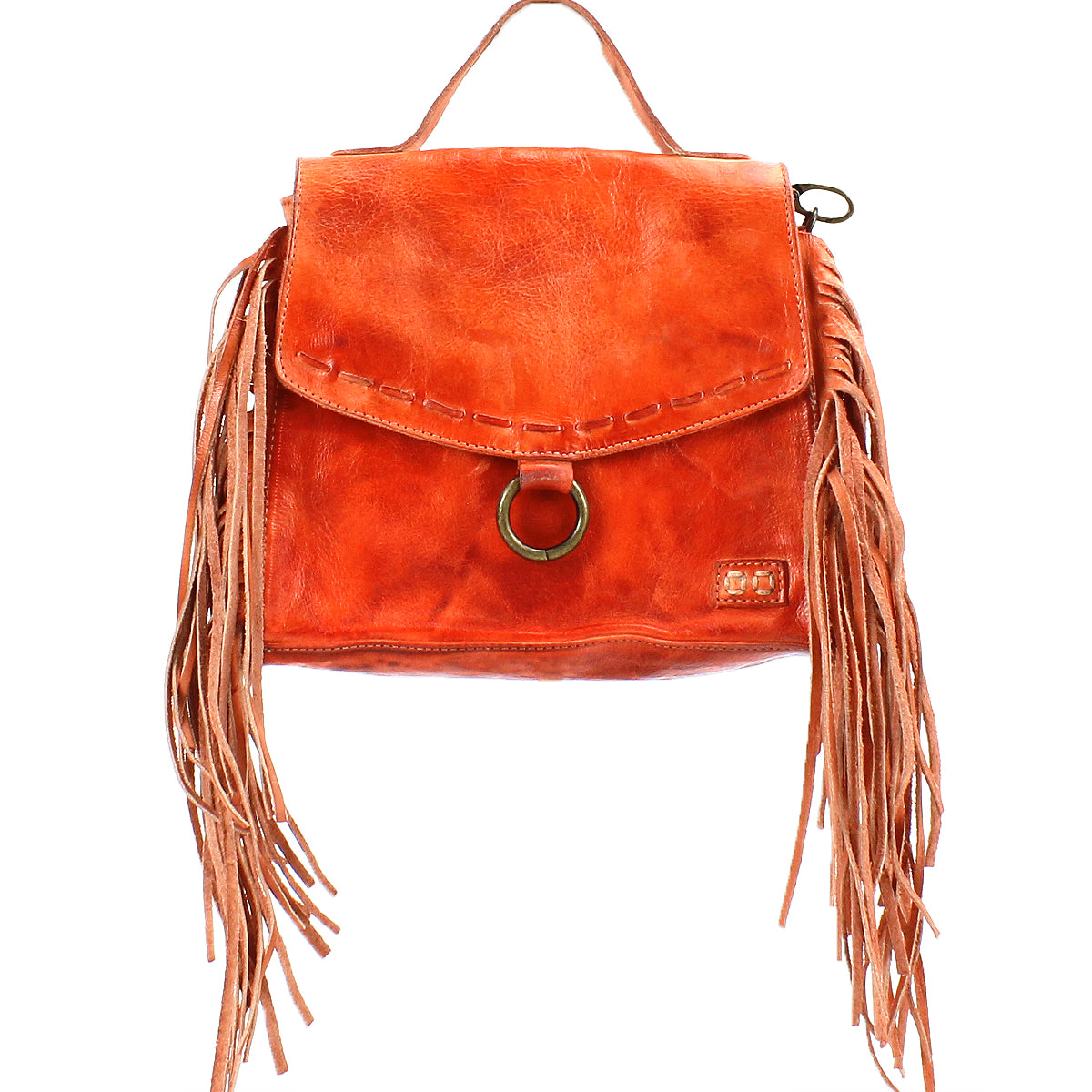 The Bed Stu Hidden is an orange leather crossbody bag with a top handle and long side fringe. It has a flap closure, highlighted by a circular metal ring accent, and offers versatile wear with an adjustable strap.