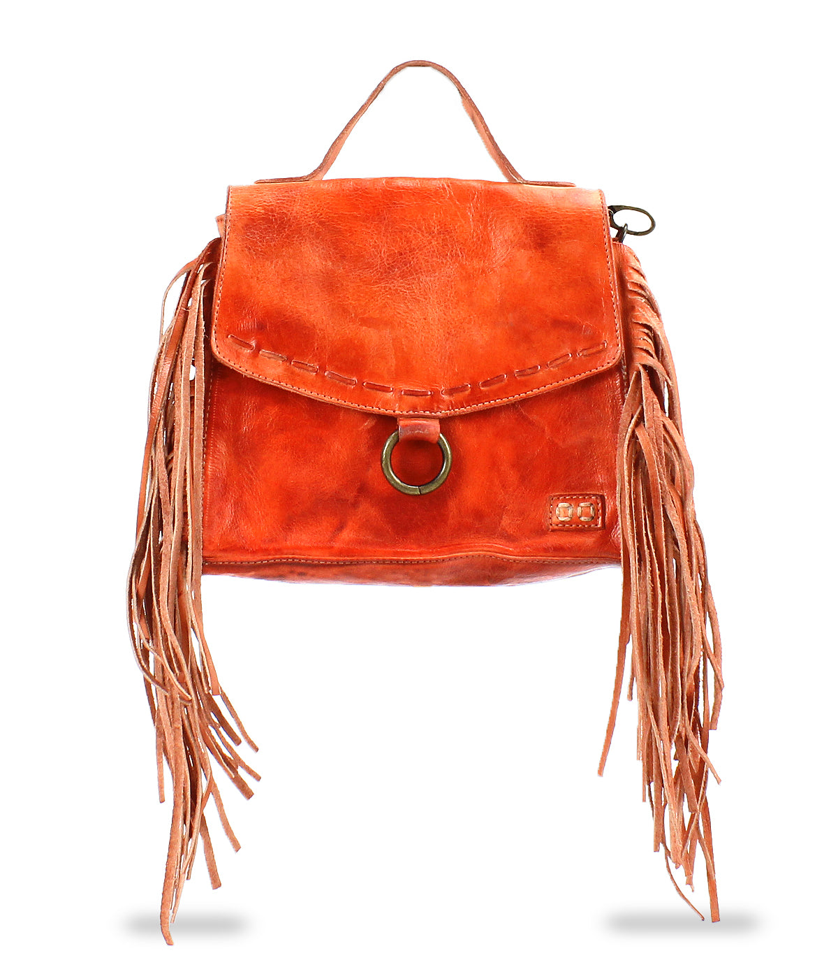 The Bed Stu Hidden is an orange leather crossbody bag with a top handle and long side fringe. It has a flap closure, highlighted by a circular metal ring accent, and offers versatile wear with an adjustable strap.