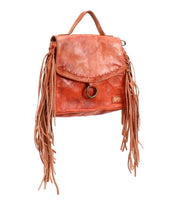 The Bed Stu Hidden is a brown leather crossbody bag with playful fringe accents, a round metal clasp, top handle, and adjustable strap for versatile styling.