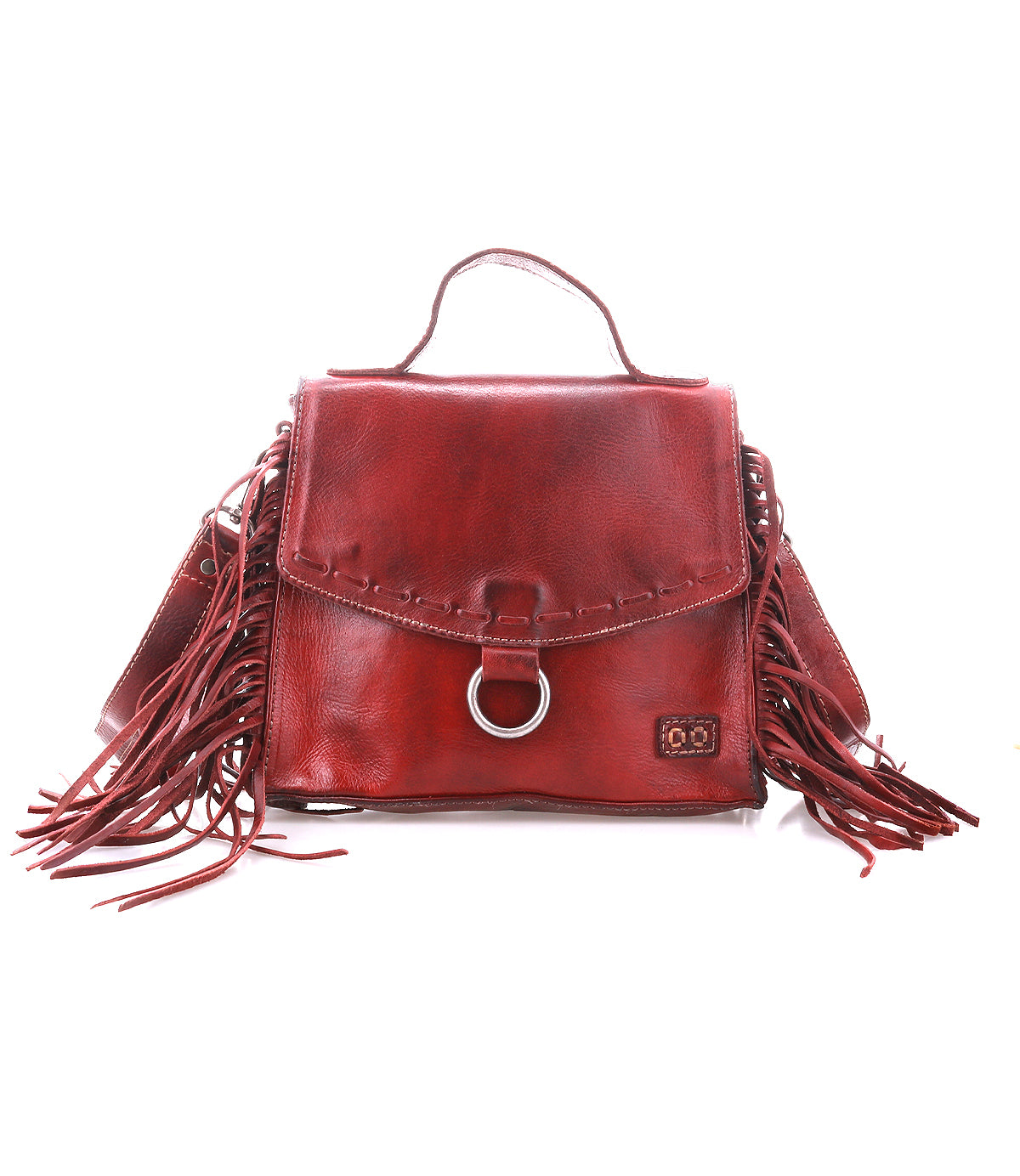 The Bed Stu Hidden is a brown leather crossbody bag featuring a top handle, adjustable strap, front flap, metal ring detail, and fringe accents on both sides.