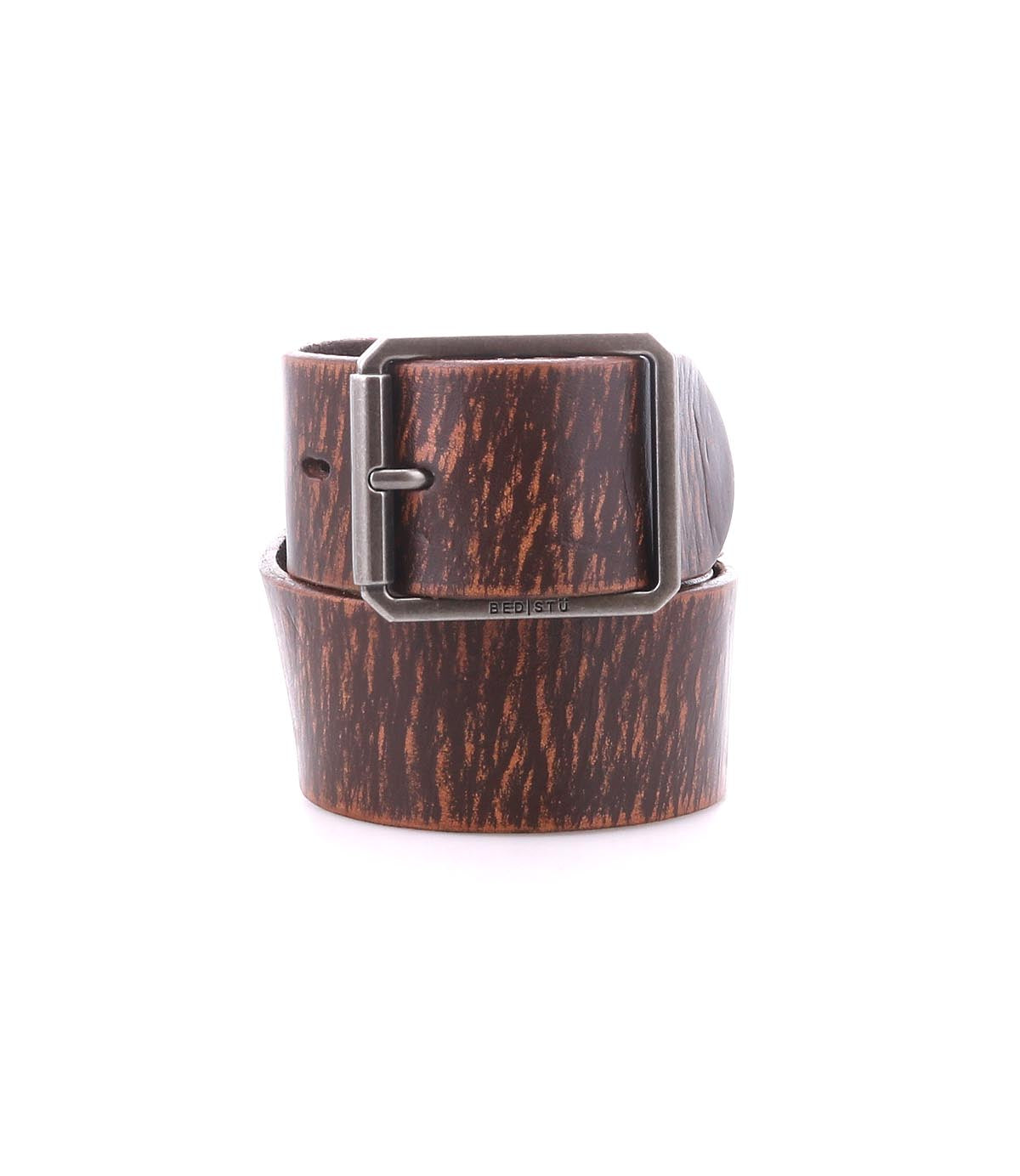 The Bed Stu Hobo men's belt in brown leather showcases a wood grain texture and a square silver buckle, elegantly coiled on a white background—an ideal dress accessory.
