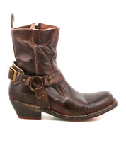 The Bed Stu Homage is a rugged men's fashion boot crafted from worn brown leather, featuring a low heel, decorative strap with brass buckle, side zipper, and square toe—perfect for adding standout style to any collection.