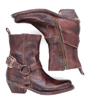 The Bed Stu Homage boots are worn brown leather ankle boots with a square toe, side zippers, buckles, and stacked heels, shown on a white background.