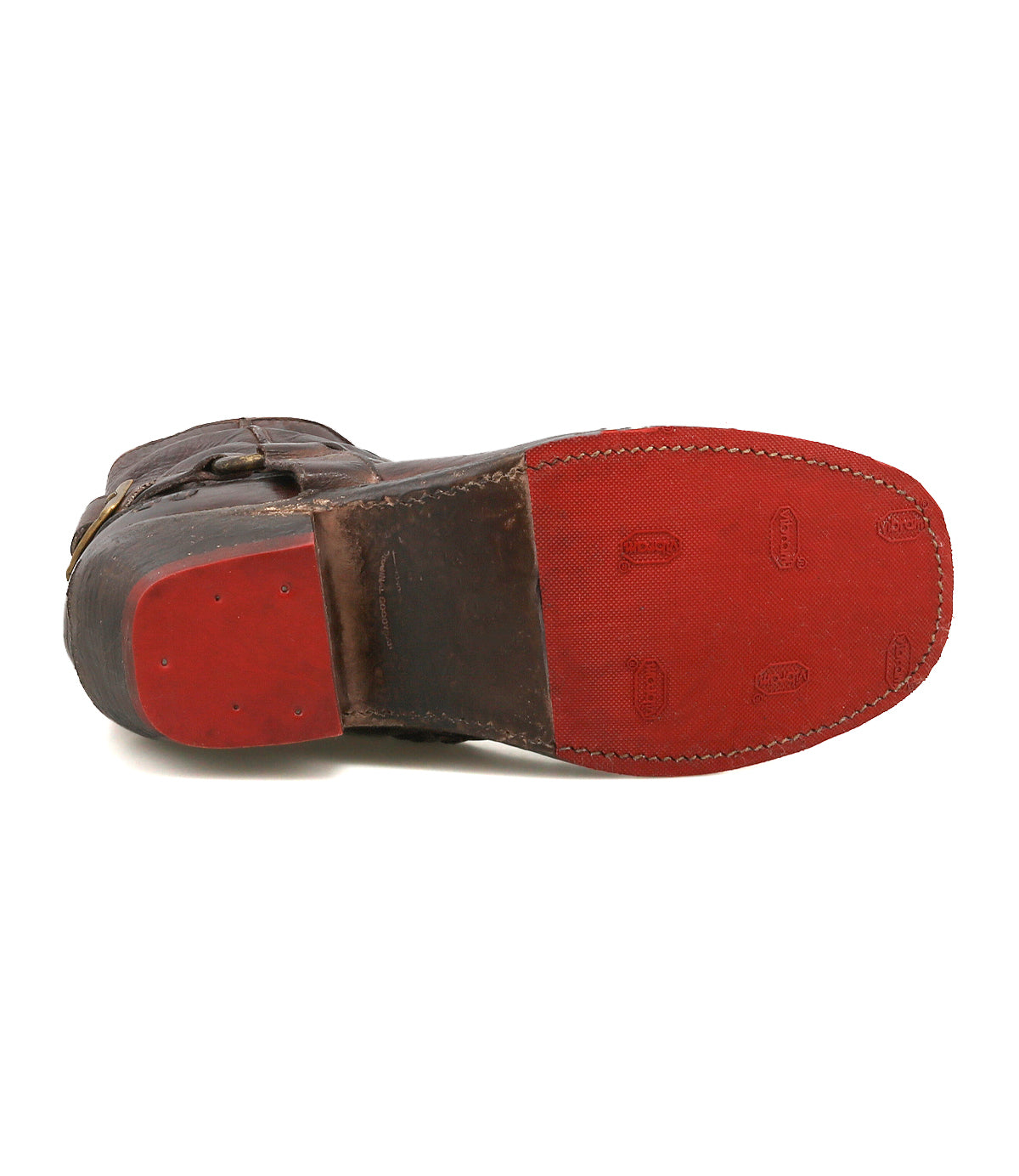 The underside of the Bed Stu Homage boot displays a brown leather harness style with a red rubber sole and heel, plus visible stitching along the edge.