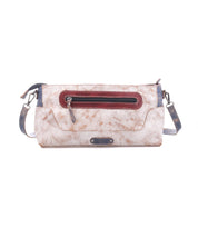 The Bed Stu Hyperbolic is a handcrafted rectangular beige leather shoulder bag with marbled texture, dark red front zipper pocket, dark blue strap, and metallic hardware, shown against a white background.