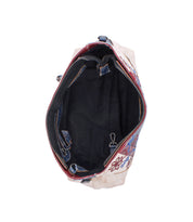 The Bed Stu Hyperbolic is a handcrafted leather shoulder bag with a bohemian-inspired floral and geometric outer pattern, black inner lining, multiple compartments, and a zipper pocket shown from the top view.