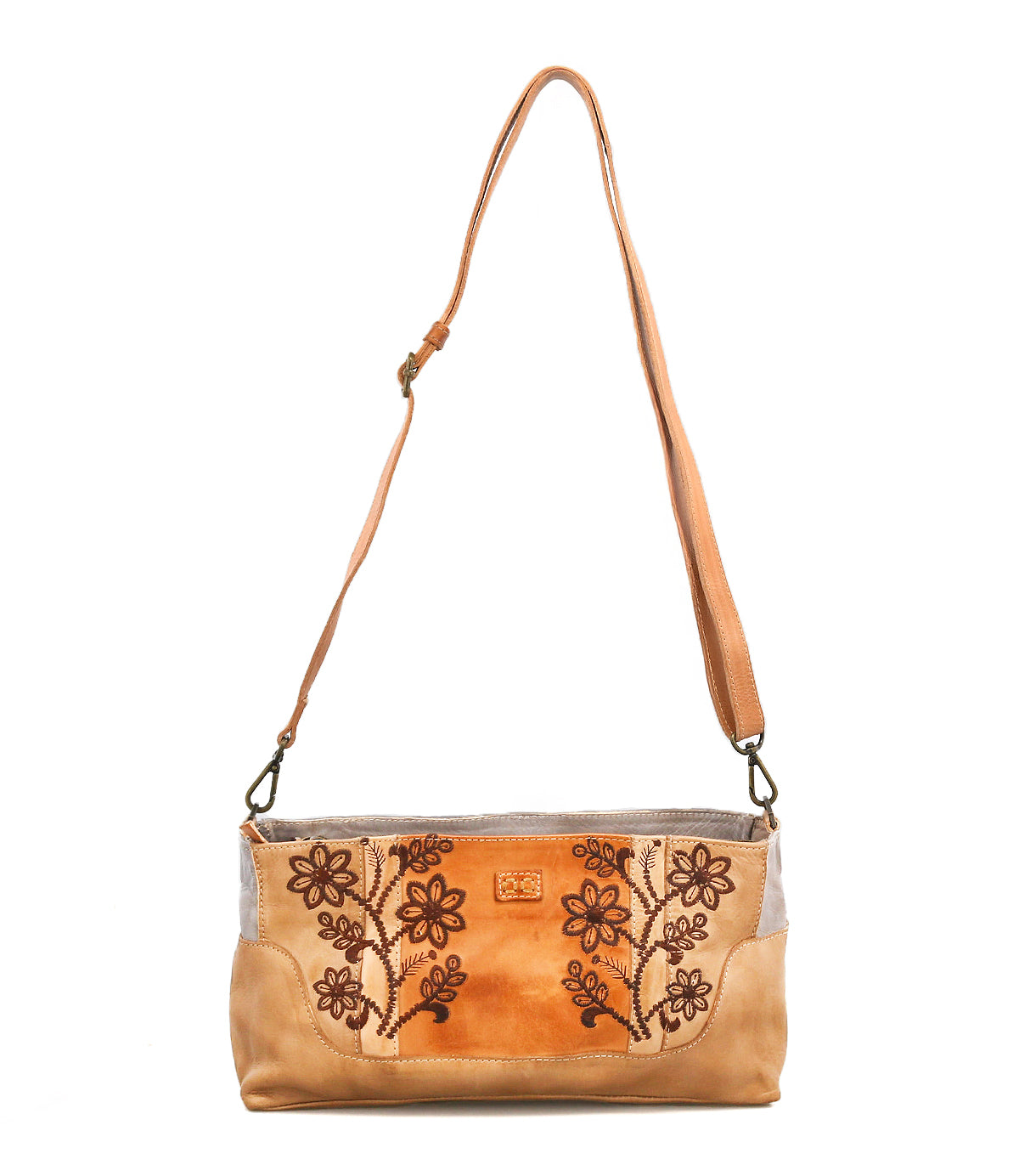 The Hyperbolic by Bed Stu is a handcrafted tan leather shoulder bag with an adjustable strap and a floral embroidered front panel in a rectangular shape.