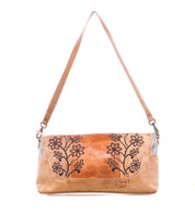 The Bed Stu Hyperbolic is a tan leather shoulder bag with floral embroidery, a single strap, and handcrafted boho details, photographed on a white background.