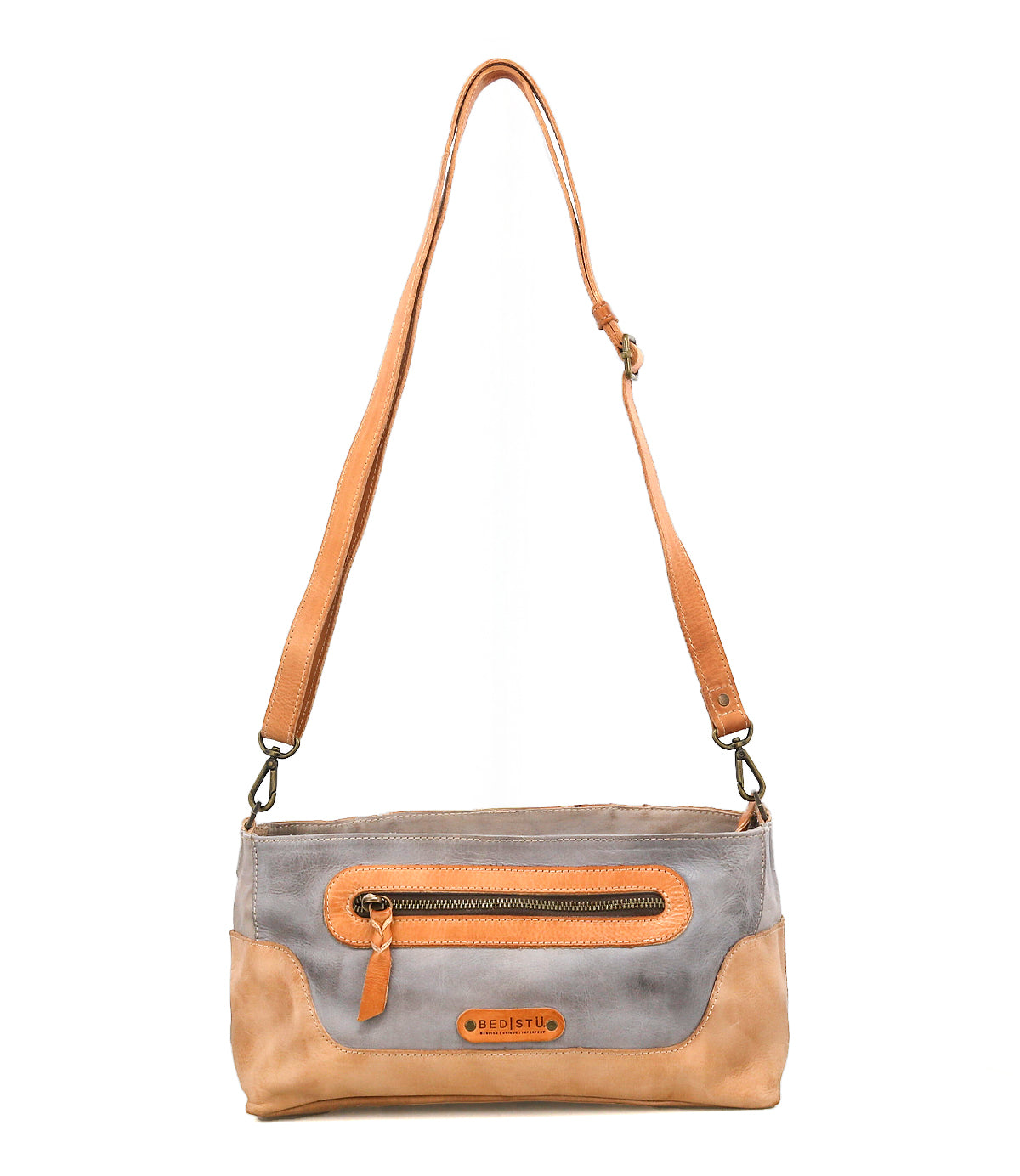 The Bed Stu Hyperbolic is a two-tone bohemian leather shoulder bag with an adjustable strap, front zipper pocket, and handcrafted logo patch on the front.
