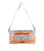 The Bed Stu Hyperbolic is a handcrafted rectangular leather shoulder bag with a gray body, brown strap and accents, front zipper pocket, and visible stitching.