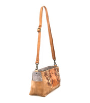The Bed Stu Hyperbolic is a tan and gray leather shoulder bag with floral embroidery, an adjustable strap, and metal hardware that exudes handcrafted bohemian charm. Shown here against a white background.