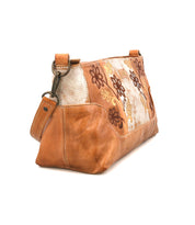The Bed Stu Hyperbolic is a bohemian brown leather and fabric shoulder bag with floral embroidery and a short strap, displayed at an angle on a white background.