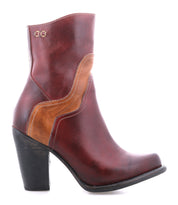 The Bed Stu Iazu is a handcrafted leather boot with a medium stacked heel, decorative stitching, and a distinctive wavy tan accent on the side.