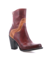 The Bed Stu Iazu is a handcrafted leather boot in brown and tan, featuring a chunky stacked heel, decorative stitching, and a square toe, shown against a white background.