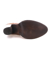 Top view of the Bed Stu Iazu boot's sole, showing stitched edges, a pointed toe, and a stacked black heel with three visible metal nails.