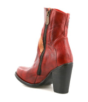 The Bed Stu Iazu is a handcrafted red leather boot with a square toe, mid-height stacked heel, side zipper, and visible stitching, displayed on a white background.