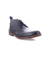 An Illiad men's blue leather chukka boot by Bed Stu, on a white background, made with natural materials.