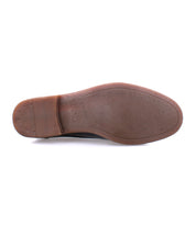 Sole of a brown leather chukka boot with textured grip and Bed Stu imprint visible, isolated on a white background.