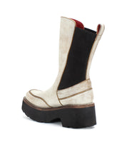 The Illicit platform ankle boot by Bed Stu, crafted from white leather with black accents and a bold black platform sole, showcases nostalgic fashion with its retro flair when viewed from the side.
