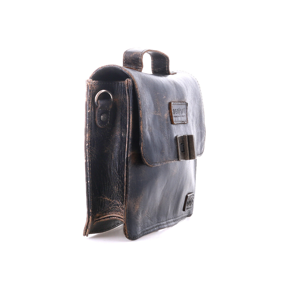 The Bed Stu Improv is a dark brown leather satchel with a flap closure, side metal ring, and top handle—combining fashion and functionality for a timeless look, shown upright on a white background.