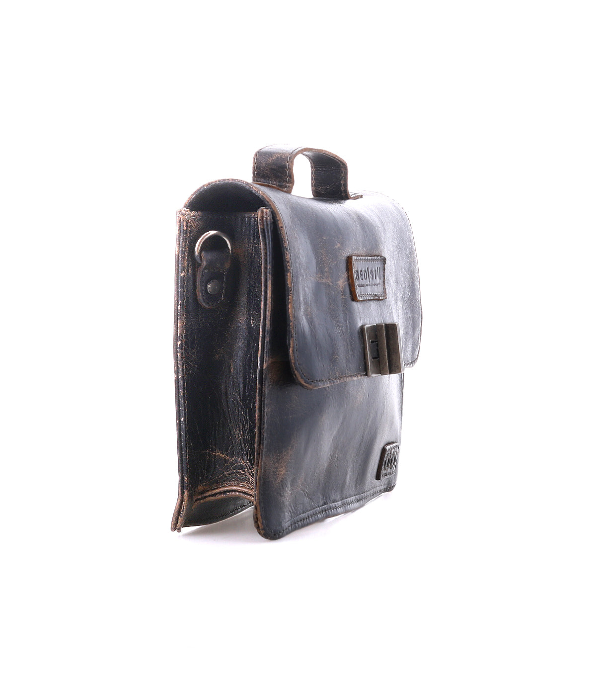 The Bed Stu Improv is a dark brown leather satchel with a flap closure, side metal ring, and top handle—combining fashion and functionality for a timeless look, shown upright on a white background.