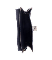 Top view of the Bed Stu Improv, an empty black mini purse with visible stitching and a metal clasp, photographed against a white background.