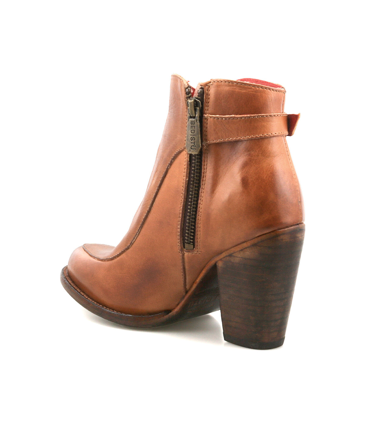 The Bed Stu Isla bootie is a tan leather heel with a side zipper, chunky stacked heel, and subtle vintage buckle detail, shown from a rear side angle against a white background.