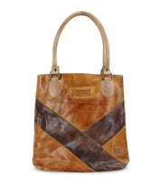 The Italic handbag by Bed Stu features a classic brown leather design with a darker brown diagonal stripe, two beige handles, and a small rectangular logo patch on the front. This spacious tote bag comfortably holds all your essentials.
