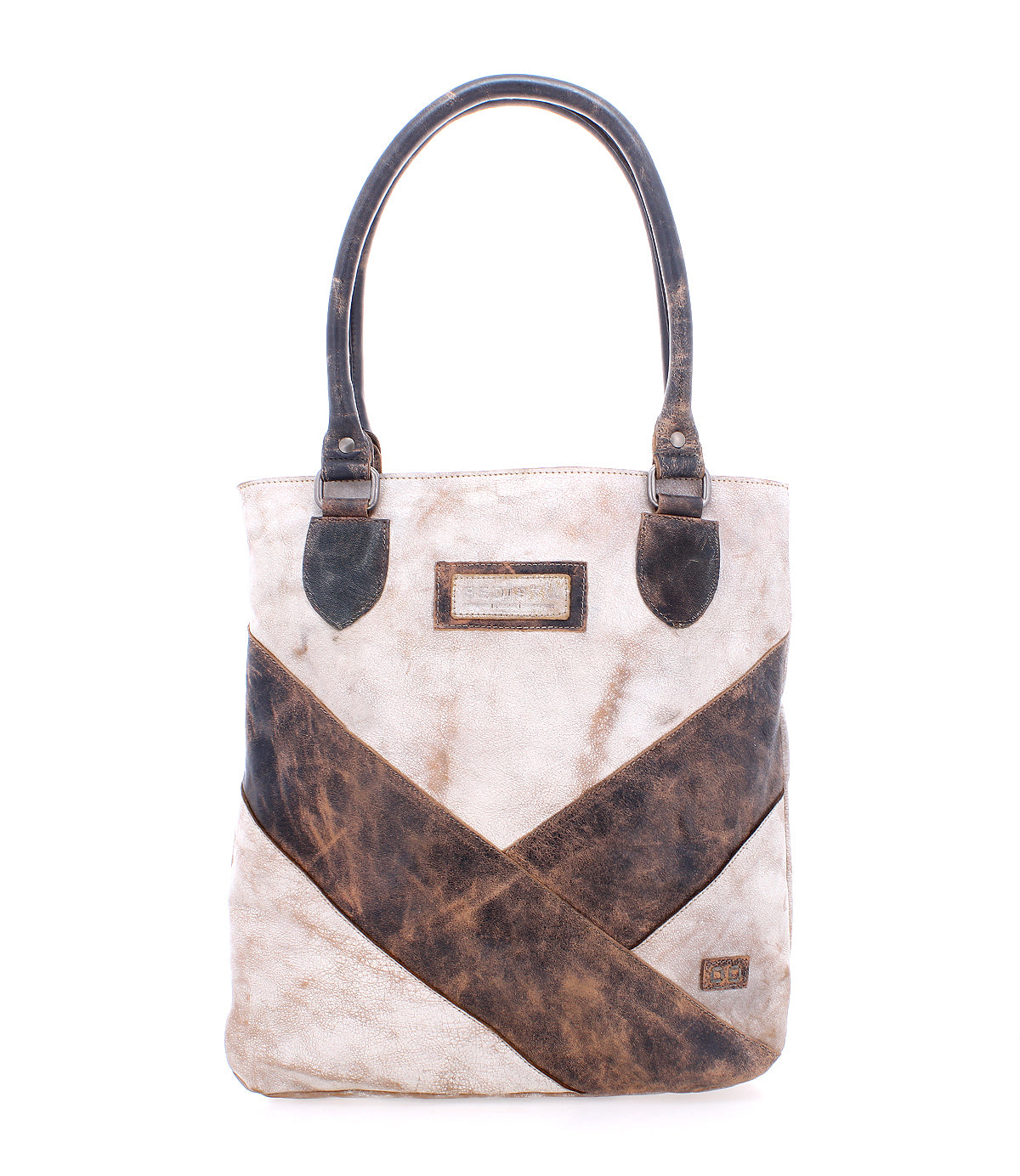 The Italic tote bag by Bed Stu is beige and brown leather with dark handles, a spacious interior, crisscross design, and features a rectangular label on the front.