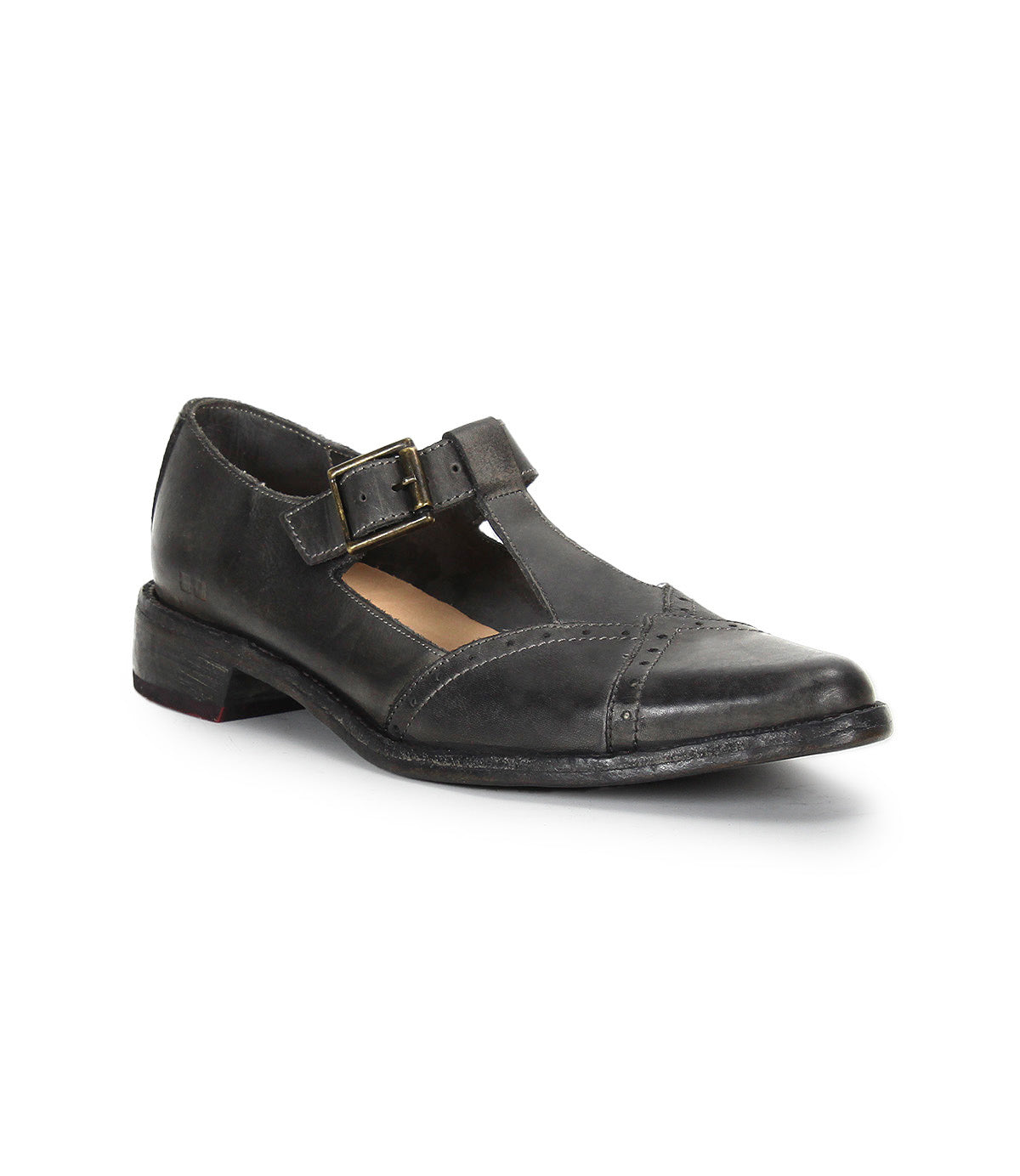 The Jenny by Bed Stu is a black leather Mary Jane casual shoe featuring a low heel, T-strap pointed toe design, cushioned insole, buckle closure, and slightly worn finish.