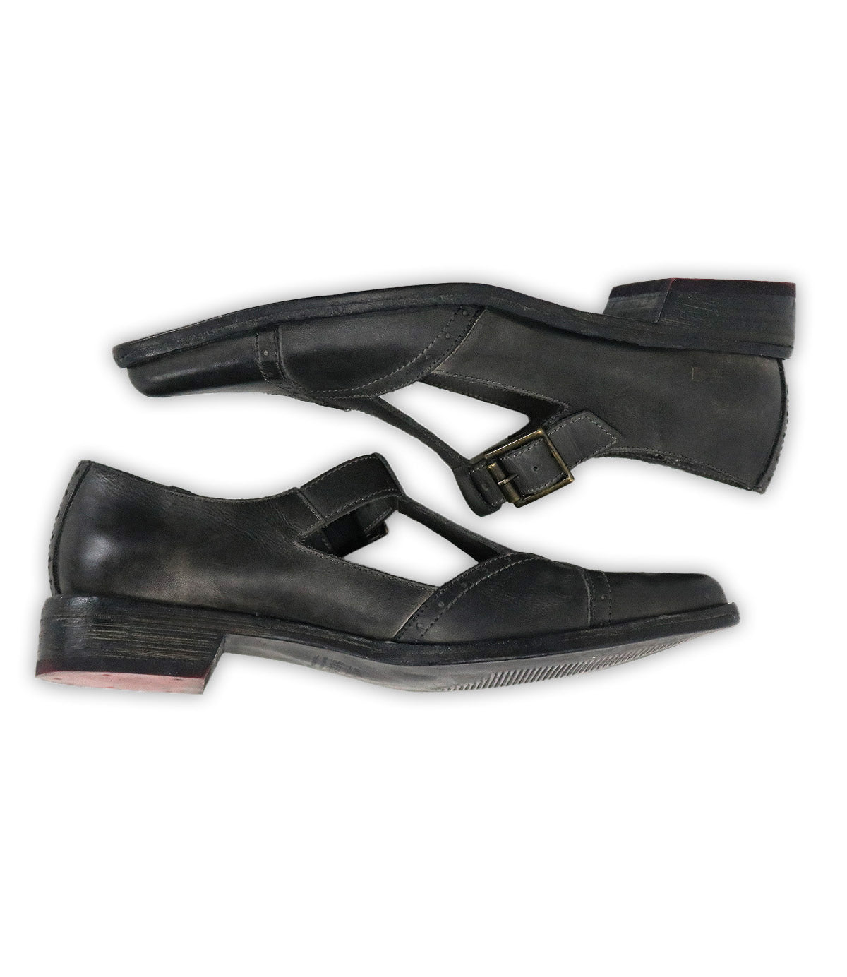The Bed Stu Jenny is a pair of black leather Mary Jane casual shoes with buckle straps, cushioned insole, and low heels, shown from the side against a white background.