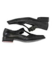 The Bed Stu Jenny is a pair of black leather Mary Jane casual shoes with buckle straps, cushioned insole, and low heels, shown from the side against a white background.